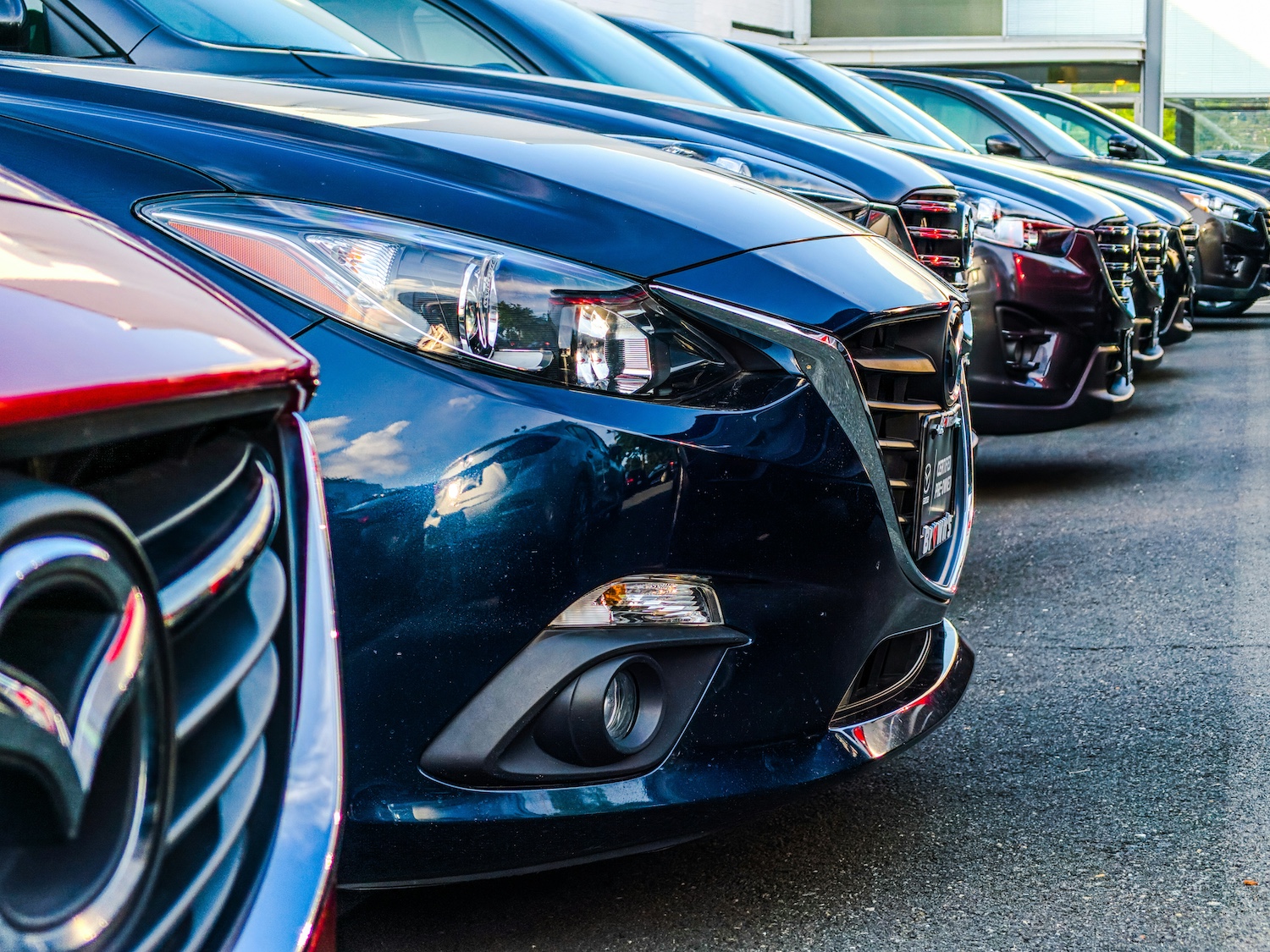 Row of a fleet of cars lined up in a carpark