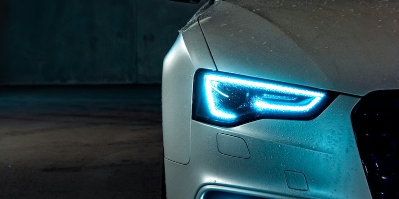 Exterior headlights of a white audi fleet car