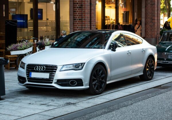 White luxury audi parked on the street outside a high end store for corporate car leasing