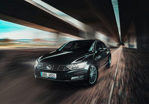 New Volkswagen fleet car being driven under a motorway underpass